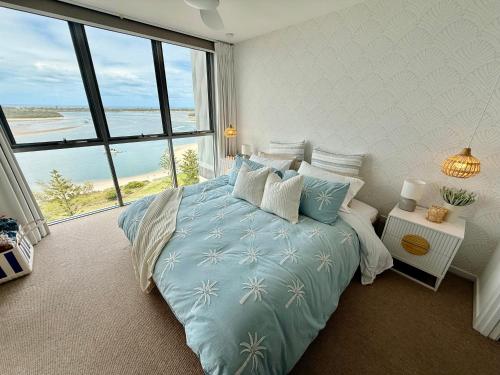 a bedroom with a bed with a view of the ocean at Vitamin Sea - Gold Coast luxury on the lagoon in Gold Coast