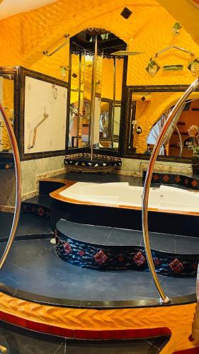 a stage with a tub and a sink in a room at PENTHOUSE PATTAYA in Pattaya