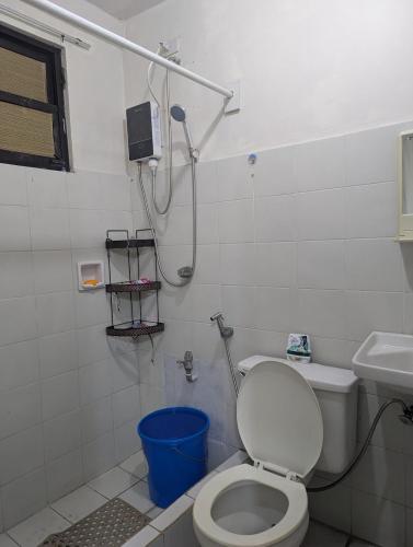 a small bathroom with a toilet and a shower at Tagaytay Resthouse 3 big rooms in Ulot