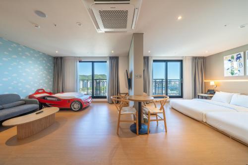a hotel room with a bed and a red car at Chestertons Gyeongju in Gyeongju