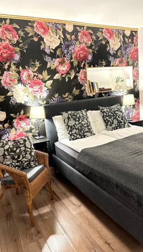 a bedroom with a bed and a floral wall at Pasta Factory Guest Rooms in Galway