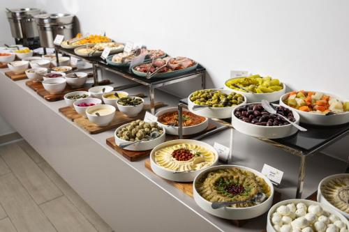 a buffet line with many different types of food at Nest Hotel, Aljada in Sharjah