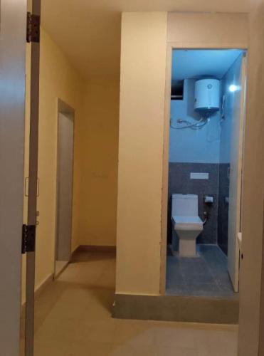 a bathroom with a toilet in a hallway at Hangout at Nandi Hills in Nandigunda