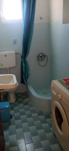 a bathroom with a toilet and a sink at Panoramic Seaview Apartments - Koroni in Koroni