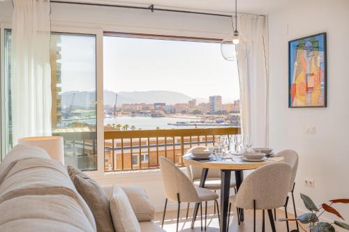 a living room with a table and a large window at C36 Elegant 2 bdr apt Amazing Views in Málaga