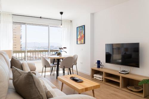 a living room with a couch and a table at C36 Elegant 2 bdr apt Amazing Views in Málaga