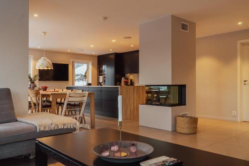 a living room and kitchen with a couch and a table at Intersporthytta Sogndal in Sogndal