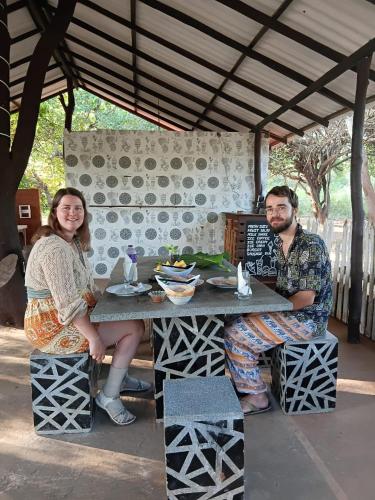 a man and a woman sitting at a table at Yala Thaman Katharagama in Kataragama