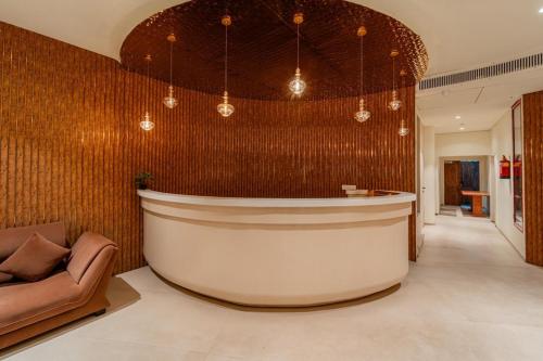 a large lobby with a large tub in a room at Hotel Benchmark Premier in Indore