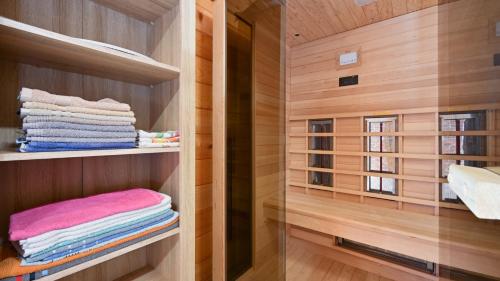 a walk in closet with wooden walls and towels at Villa Nina by Villas Guide in Ludbreg