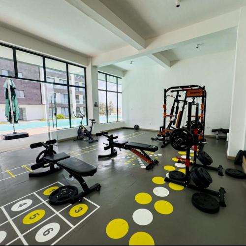 a gym with several treadmills and machines in a room at Ideal homes in Gatunga