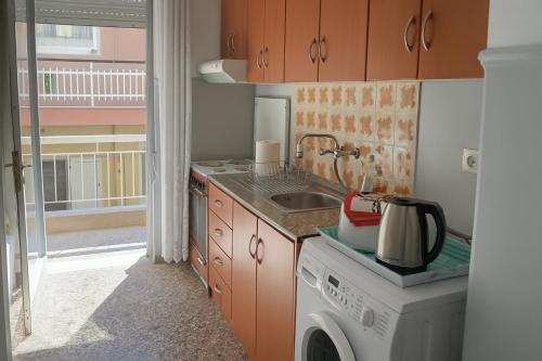 a kitchen with a washing machine and a sink at Balcony Sea Hanioti Stay in Hanioti