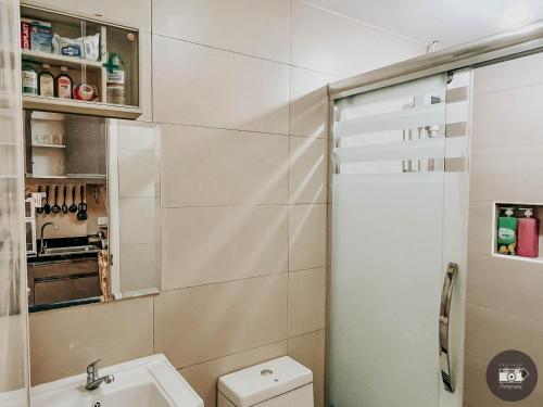 a bathroom with a toilet and a sink at Modern Studion with 2 Queen Bed in Sampong