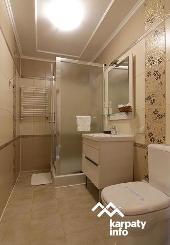 a bathroom with a shower and a toilet and a sink at Georgiy in Oryavchyk