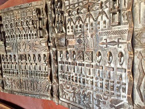 a wall with a relief of hieroglyphics on it at Nemasu Eco-lodge in Gunjur