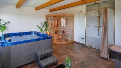 a large bathroom with a hot tub and a shower at Dvori Perdedaj by Villas Guide in Beretinec