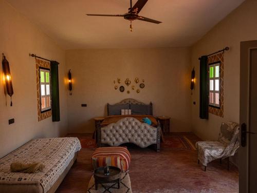 a bedroom with two beds and a ceiling fan at Lodge bio berber nomad in Nkob