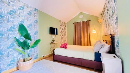 a bedroom with a bed and a potted plant at Modern House with Pool in Grand-Baie