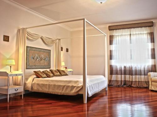 a bedroom with a bed with a canopy at Villa Glicini in Lamezia Terme