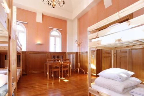 a room with a table and a dining room with bunk beds at Pronova Hotell & Vandrarhem in Norrköping
