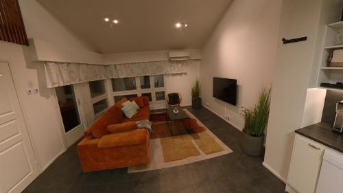a living room with a couch and a television at Keskuskarintie 9 A3 in Kalajoki