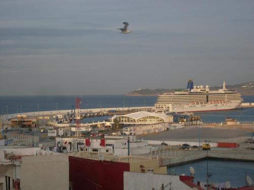 a cruise ship is docked in a harbor at The Medina Hostel in Tangier