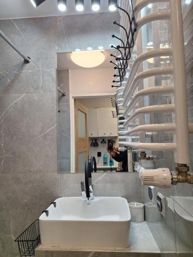a bathroom with a sink and a mirror at Noclegi 2 pokoje in Szczecinek