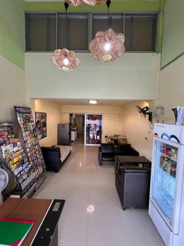a room with a store with couches and a refrigerator at City Capsule Hostel in Chiang Mai