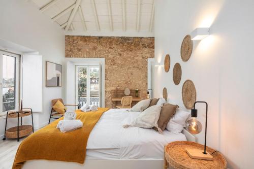 a bedroom with a large bed and a table at Alma da Vida Ferragudo in Ferragudo