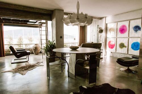 a living room with a table and chairs at Luxury Waterfront Loft with Panoramic Views in Caminha