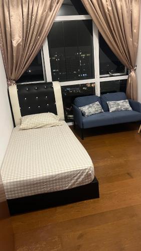 a room with two beds and a window with a city at High floor City view 2BR condo in Johor Bahru