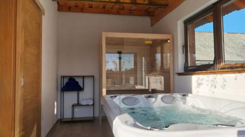 a large bathroom with a tub with water in it at Villa D-Ika by Villas Guide in Brušane