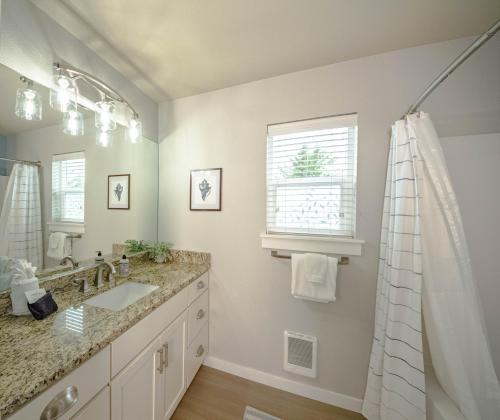a bathroom with a sink and a mirror at Hydrangea Hideaway in Ocean Shores