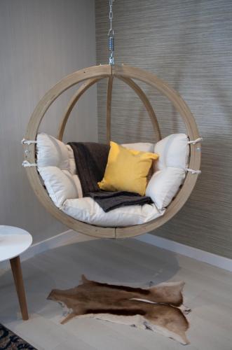 a round hanging chair with pillows at Albero Apartment in Eyemouth