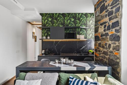 a living room with a couch and a stone wall at Appartamento Porta Torre - Porta Torre-Centro in Como