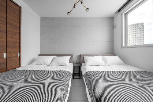 two beds sitting next to each other in a room at Grandia 302 in Sapporo