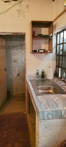 a kitchen with a sink next to a door at Yua Residence in Machakos