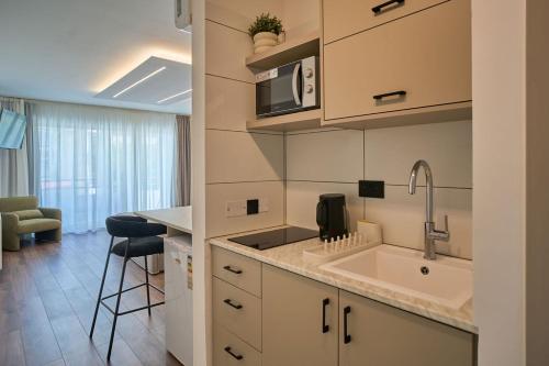 a kitchen with a sink and a counter top at Marianna Hotel Apartments in Limassol