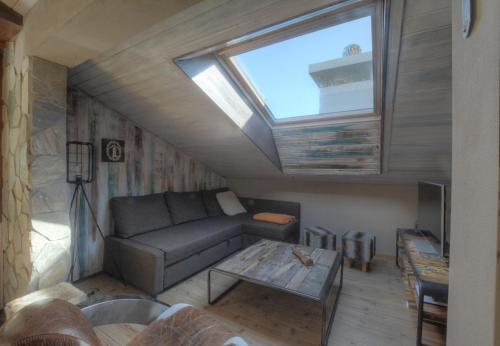 a living room with a couch and a window at Antares 507, au centre a Anzere in Anzère