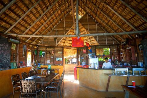 
a restaurant with tables and chairs inside of it at Ecolodge Tubagua Puerto Plata in Tubagua
