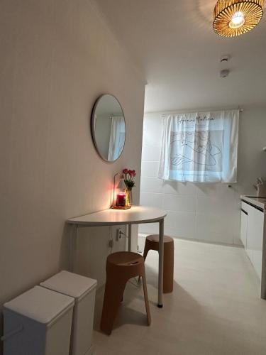 a small kitchen with a table and a mirror at Hill-house in Samgong