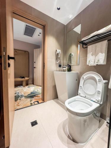 a bathroom with a white toilet in a room at Green gobi hotel in Dalandzadgad