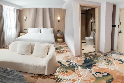 a hotel room with a bed and a couch at Green gobi hotel in Dalandzadgad