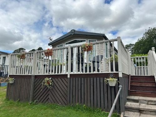 a house with a white fence and a gate at 26 Golf View in Jedburgh