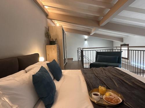 a bedroom with a bed with a tray of food on it at The Hangar Loft - Leonoardo, Center & Parking in Sesto Calende