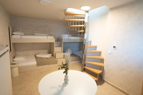 a small room with two bunk beds and a table at Villa Kukurina - luxury service with view in Potocnica