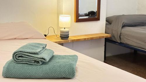 a room with a bed with two towels on it at Garibaldi by LigurianLife in Vallebona
