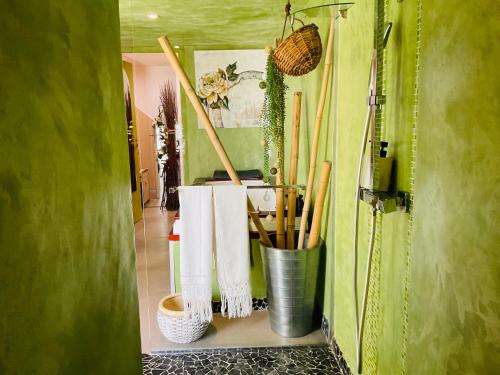 a bathroom with a rack of utensils and towels at Gîte EMOZIONE in Guebwiller