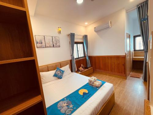 a bedroom with a bed with a teddy bear on it at Sea Night - Sea Home Hotel in Phan Thiet