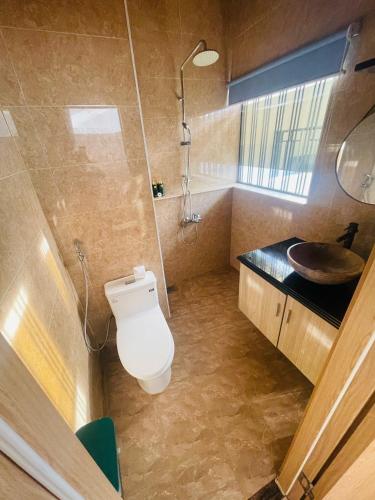 a bathroom with a toilet and a sink at Sea Night - Sea Home Hotel in Phan Thiet